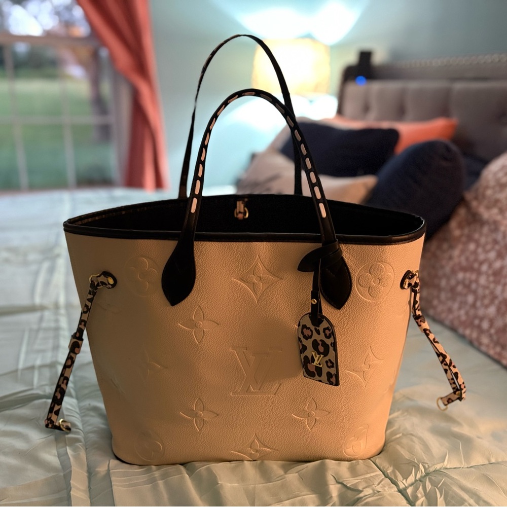 Louis Vuitton Cream Tote Bag with a pink and black leopard design!